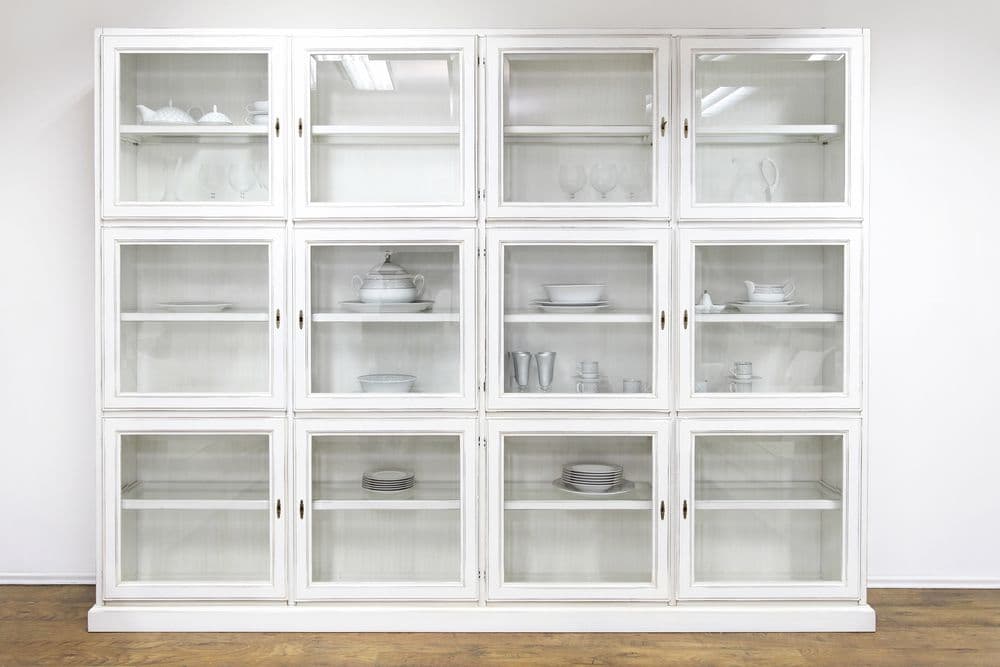 Custom glass display cabinet with tempered glass doors showcasing elegant table tops and glassware, ideal for enhancing interiors.