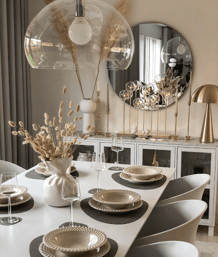 Modern dining room featuring a large round mirror