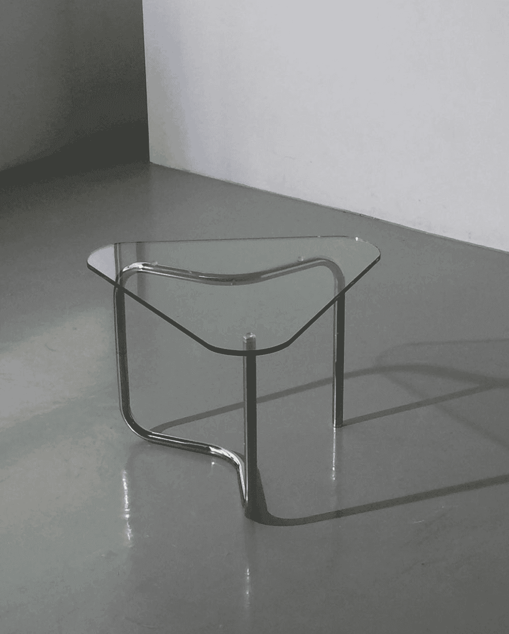 custom glass table top with unique shape and chrome legs