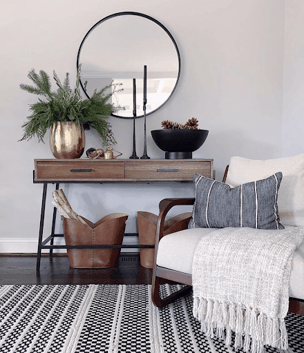 Modern living room featuring a stylish round mirror above a wooden console table