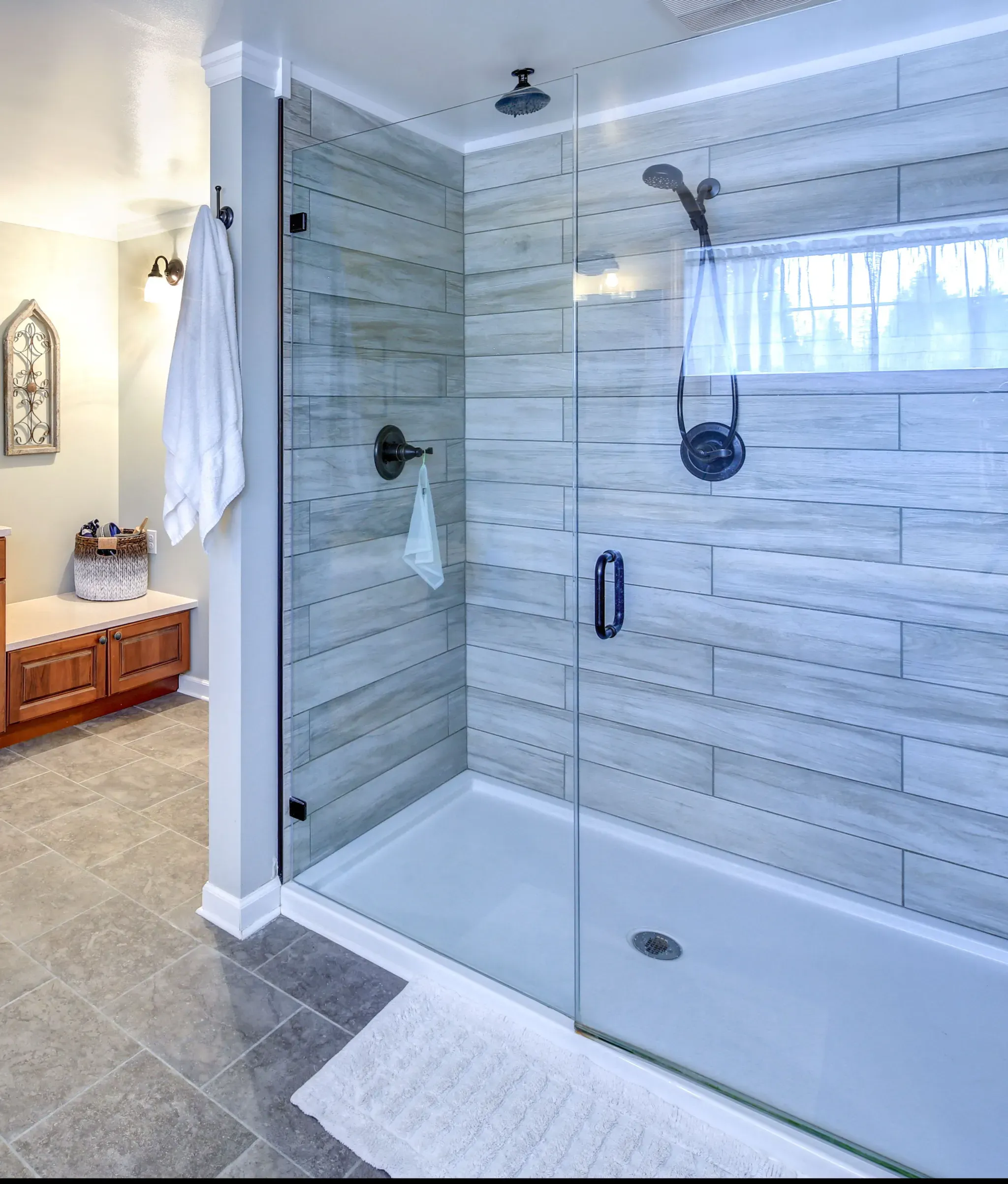 Modern bathroom featuring custom glass shower doors, showcasing a sleek design with tempered glass and a clean, open feel.