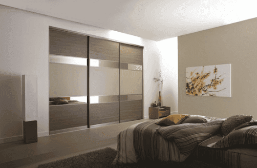 Contemporary bedroom featuring custom glass sliding wardrobe doors with tempered glass and beveled glass edge