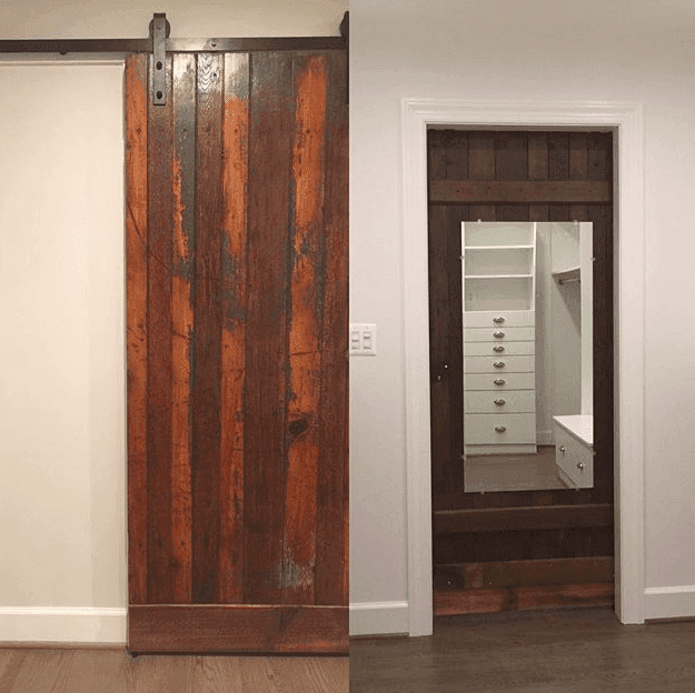 Sliding barn door and mirror frame with rustic wood accents in a modern space