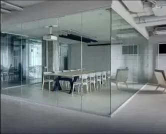 modern office space with custom glass walls, featuring tempered glass and a glass meeting room, highlighting elegant design for commercial spaces