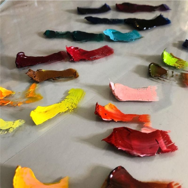 Colorful paint swatches on glass table top 