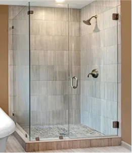 Frameless shower doors featuring custom tempered glass, showcasing a sleek design with beveled glass edges.