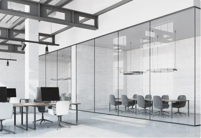 Modern office interior featuring custom glass partitions, tempered glass walls, and a stylish meeting room with sleek furniture, ideal for showcasing glass solutions like shower doors, table tops, and beveled glass edge designs.