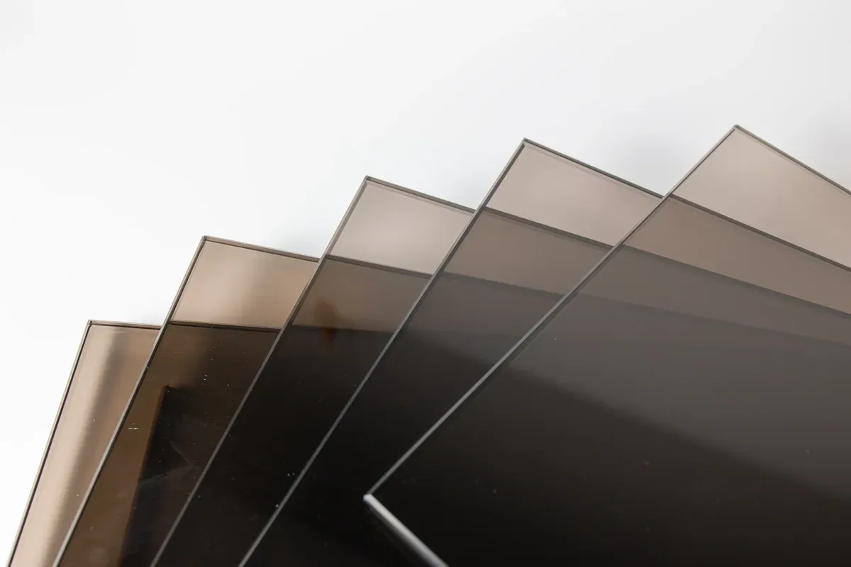 Collection of tinted tempered glass sheets suitable for custom applications like shower doors, table tops, and mirrors, featuring a sleek beveled edge.
