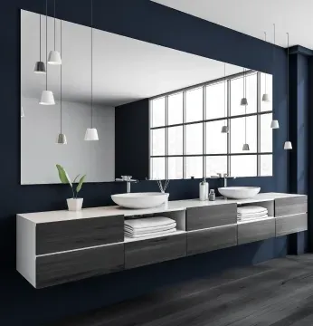 Modern bathroom featuring a large custom mirror, sleek vanity with towels, and contemporary pendant lighting, showcasing stylish design elements for custom glass solutions like shower doors and mirrors.