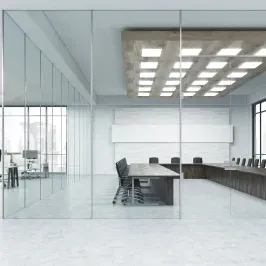 Modern conference room featuring custom glass walls, showcasing clear tempered glass for enhanced visibility and style, ideal for office spaces.