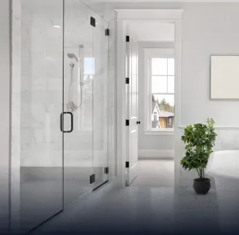 Modern bathroom featuring a custom glass shower door, complemented by a sleek mirror and elegant decor, showcasing the beauty of tempered glass.