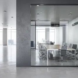 Modern office interior featuring custom glass conference room with tempered glass walls, showcasing a sleek design ideal for shower doors, table tops, mirrors, and beveled glass edges.