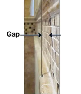 Illustration showing a gap between a wall and custom glass installation, highlighting the importance of precision for shower doors and tempered glass applications.