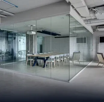 Modern conference room featuring custom glass walls, showcasing tempered glass and sleek design, ideal for business spaces utilizing shower doors, table tops, and mirrors.