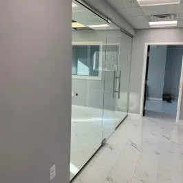 Custom glass shower doors with a sleek design in a modern interior, showcasing tempered glass.