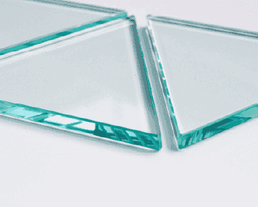 Tempered glass edges showcasing custom glass pieces for shower doors, table tops, and mirrors with a beveled finish.