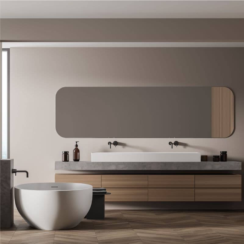 Modern bathroom featuring a sleek custom beveled glass edge mirror above a stylish sink, complemented by a luxurious freestanding bathtub and contemporary wooden cabinetry, highlighting premium materials for shower doors and table tops.