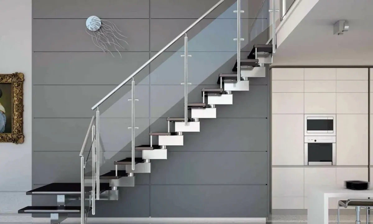 Contemporary staircase with glass railing, showcasing custom glass design elements suitable for shower doors, table tops, and mirrors, featuring tempered and beveled glass edges.