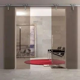 Modern custom shower doors with tempered glass, featuring a sleek design and beveled glass edges, set against a contemporary interior with a red rug and minimalist furniture.