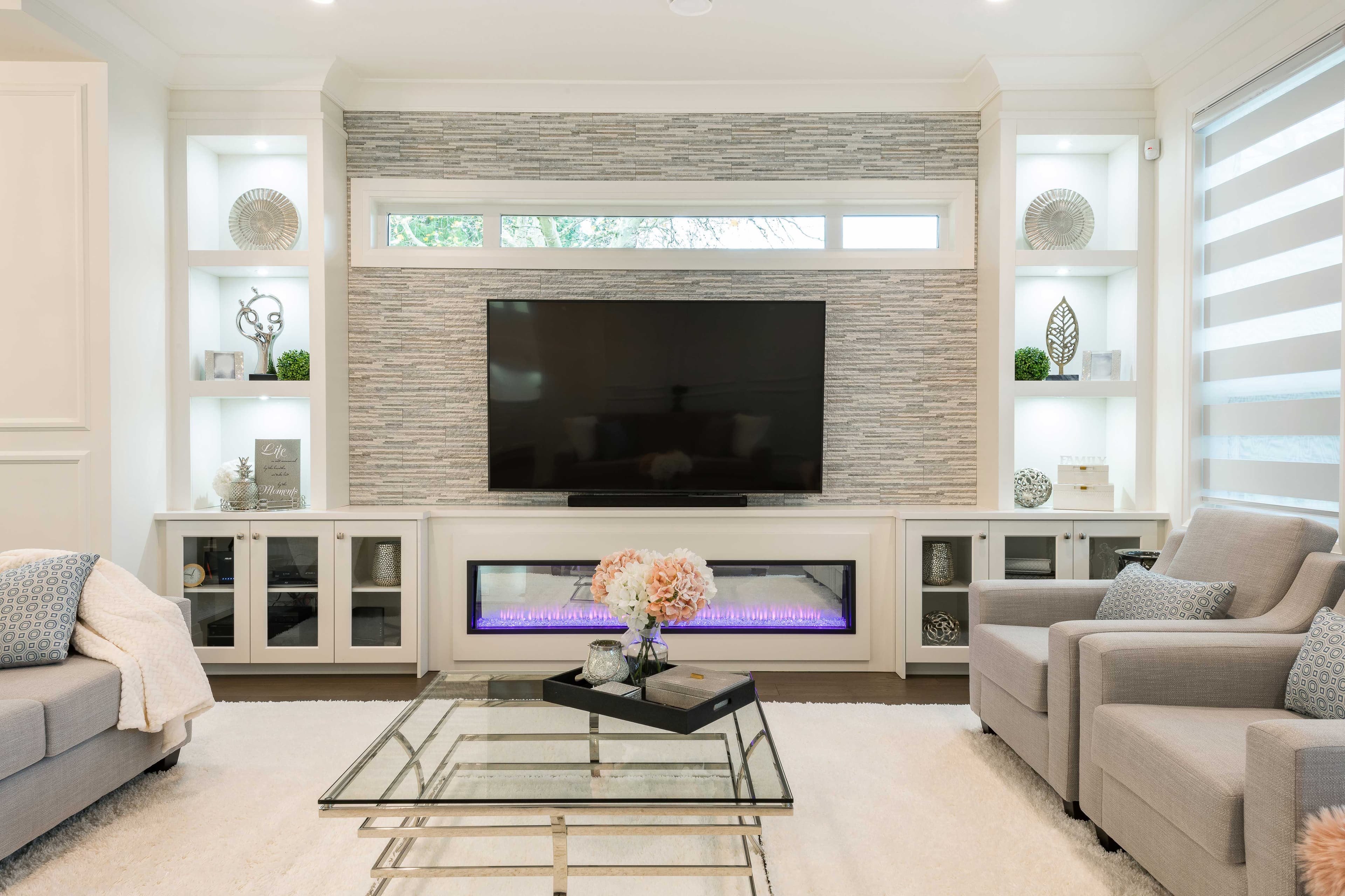 Modern living room featuring a glass coffee table, custom glass cabinet doors, and stylish decor, highlighting tempered glass elements and beveled glass edge finishes.