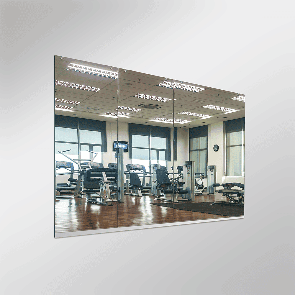 Custom glass mirror installation in a gym, showcasing clear, high-quality tempered glass for enhanced durability and style. Perfect for shower doors and fitness spaces.