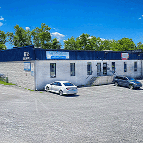 Commercial building exterior of a glass design company specializing in shower doors, table tops, mirrors, custom glass, tempered glass, and beveled glass edges.