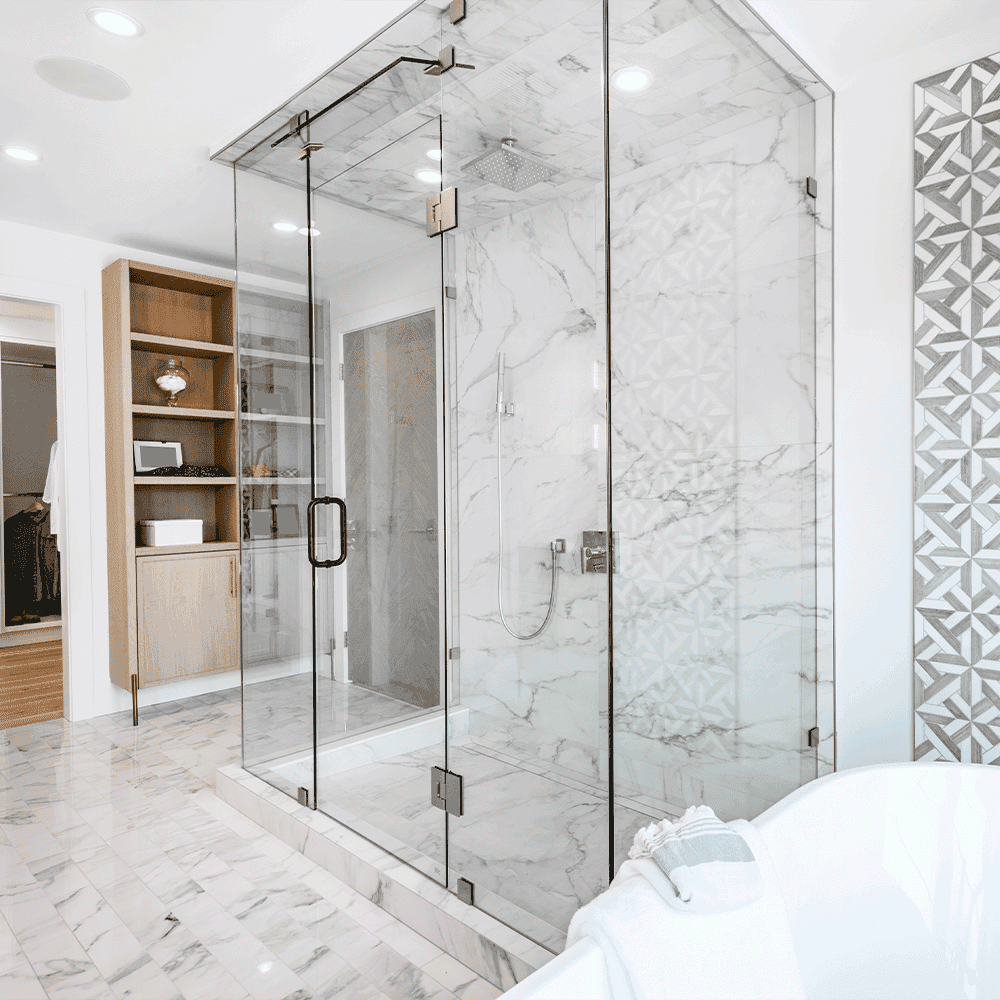 Custom shower doors showcasing tempered glass, complemented by modern tile design and elegant fixtures in a contemporary bathroom setting.