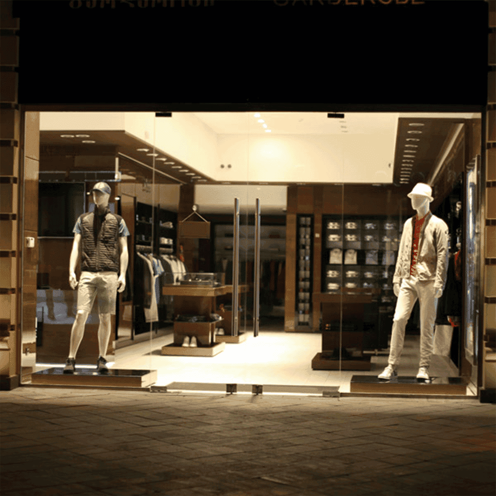 Showroom entrance featuring custom glass doors, showcasing a stylish display with mannequins, ideal for highlighting shower doors, mirrors, and tempered glass aesthetics.