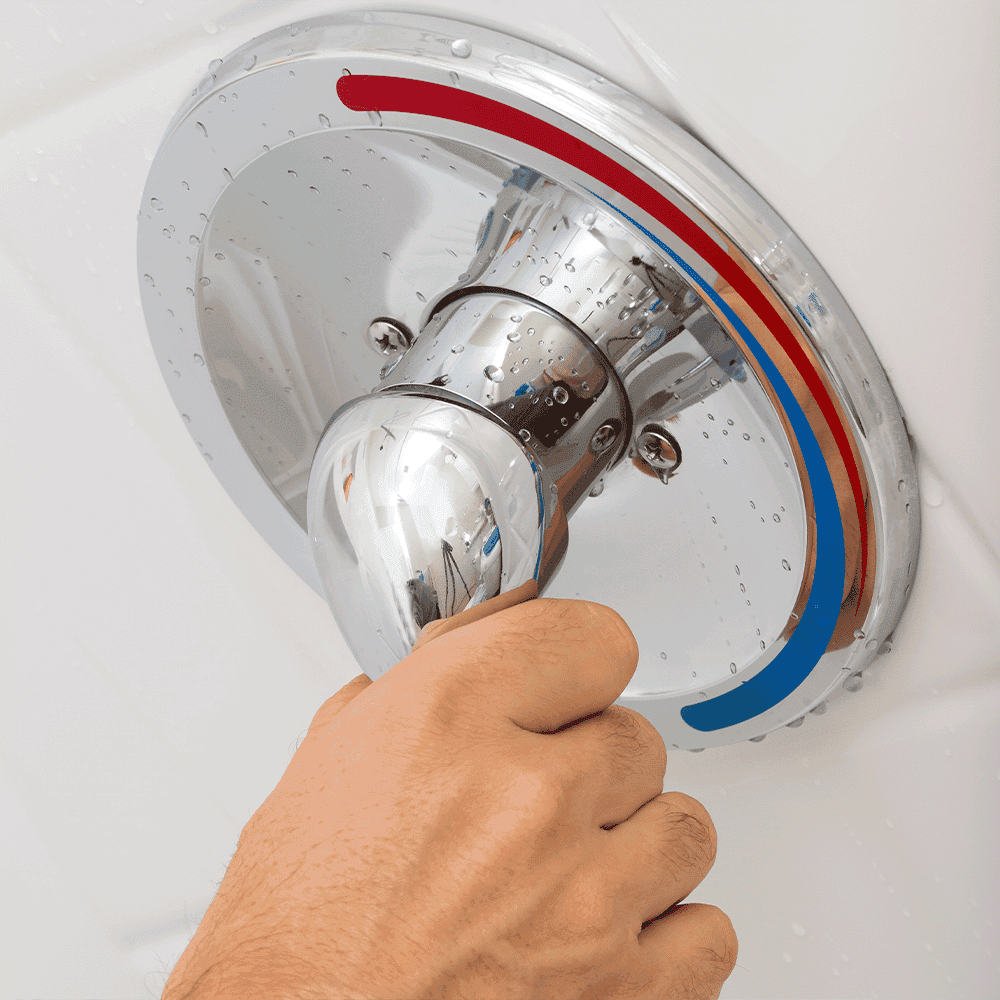 Hand adjusting a shower handle with water droplets