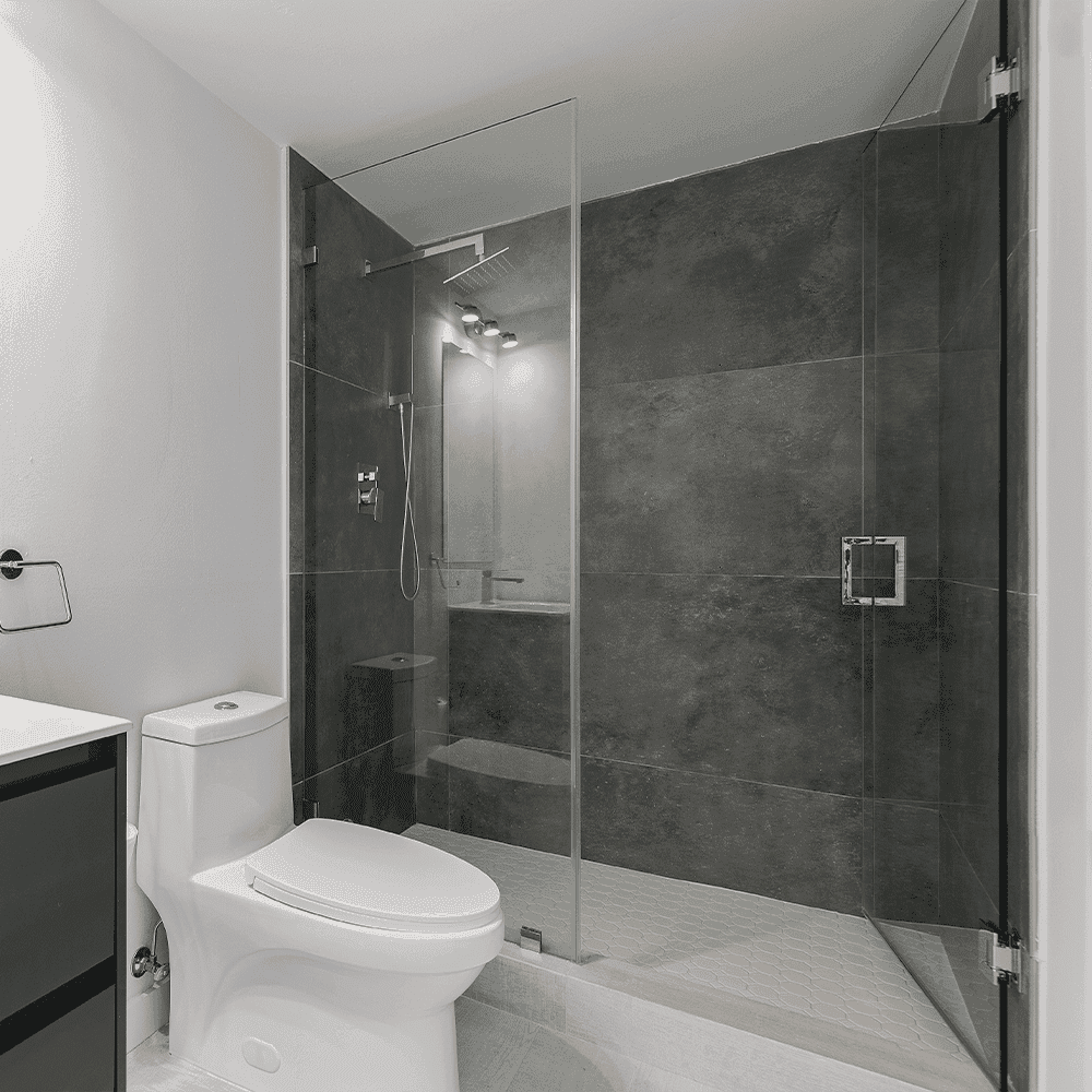 Modern bathroom featuring a shower door made of tempered glass