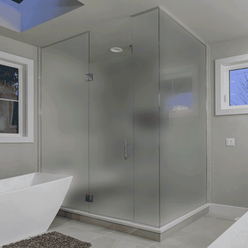Frosted glass shower doors in a modern bathroom with a freestanding tub