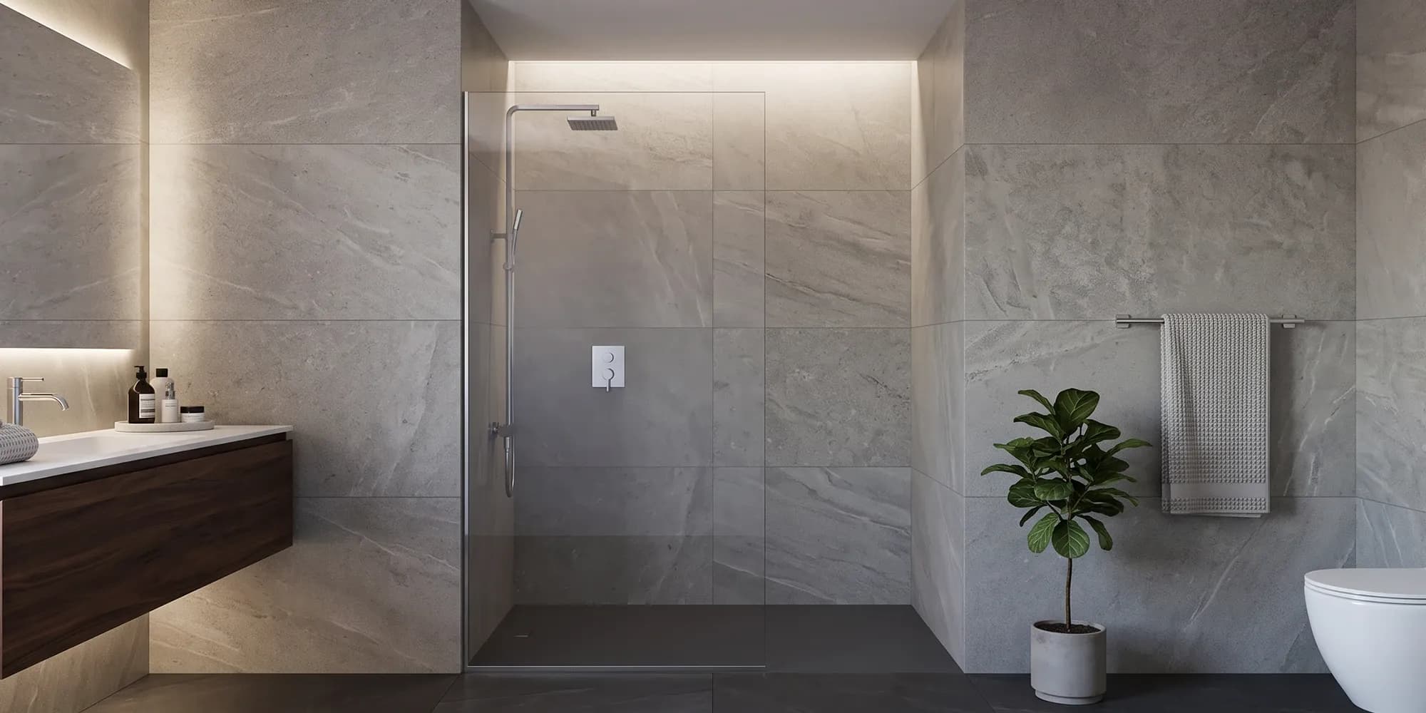Frameless fixed glass shower panel in a gray marble-look walk-in shower with a wood vanity