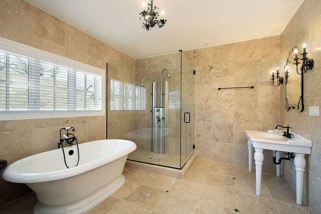 Modern bathroom featuring a sleek glass shower door, elegant free-standing bathtub, and stylish fixtures, highlighting custom glass design and tempered glass elements.
