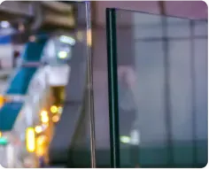 Clear tempered glass panels showcasing custom glass solutions for shower doors, table tops, and mirrors, featuring a sleek beveled glass edge.