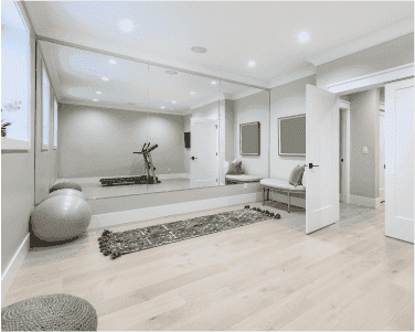 Modern interior featuring a large custom mirror, showcasing tempered glass design, with sleek lines and a minimalist aesthetic, ideal for enhancing spaces with shower doors, table tops, and beveled glass edges.